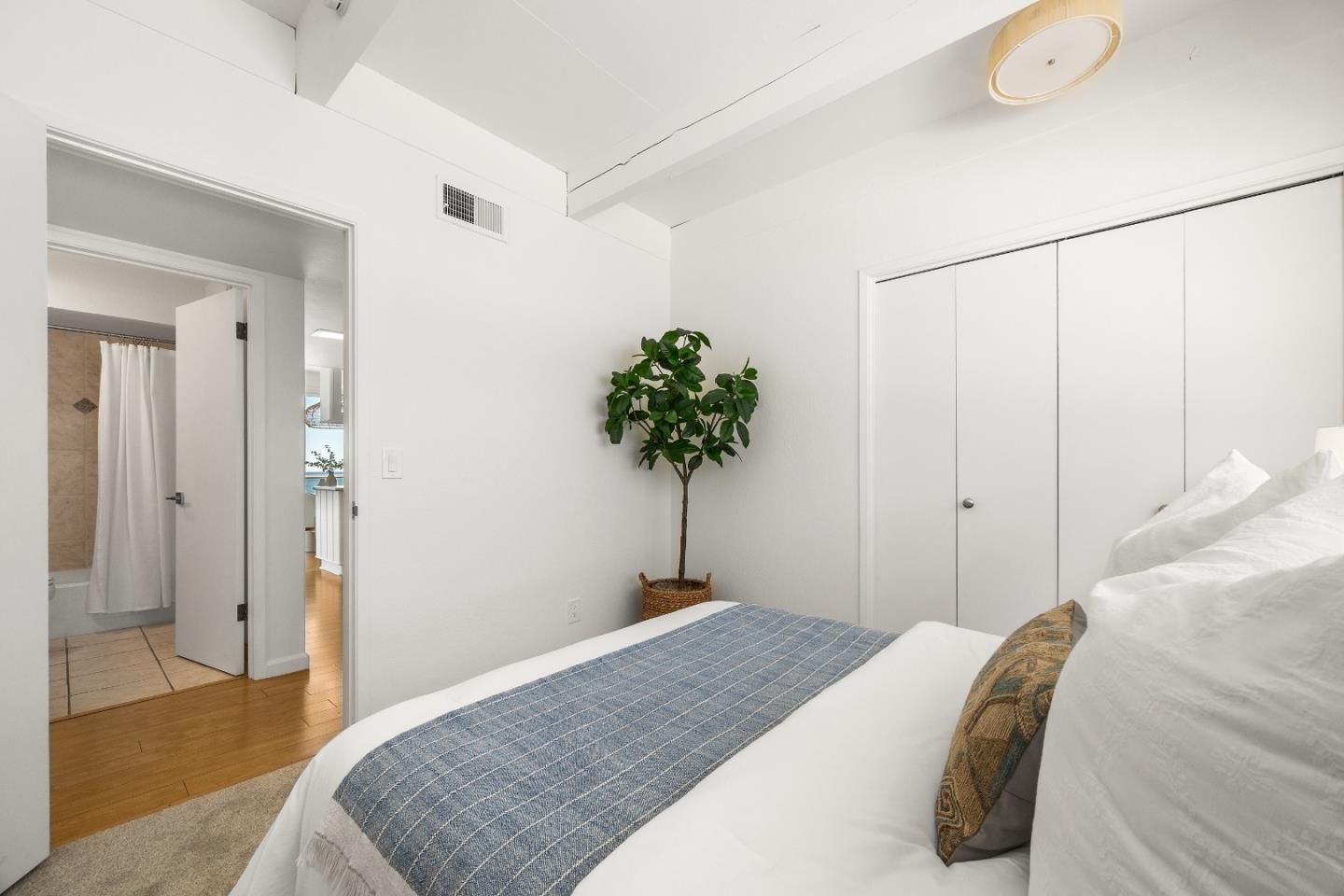 230 Rio Del Mar Boulevard, Unit K Aptos, CA 95003 - Photo 19 of 29 a bedroom with a bed and a plant