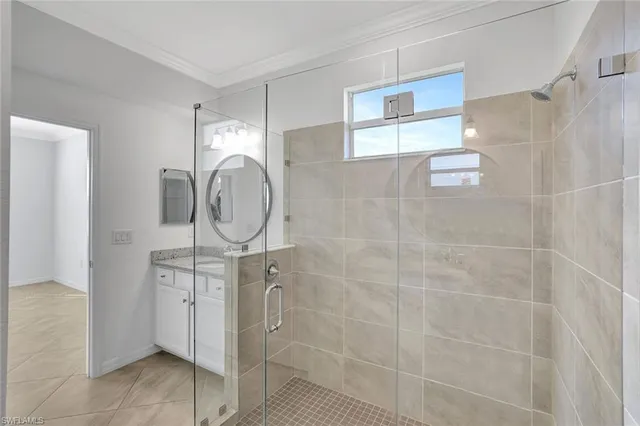 a bathroom with a mirror a shower and a sink