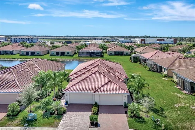 an aerial view of multiple houses with yard