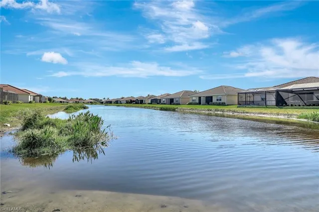 a view of a lake with houses in the background