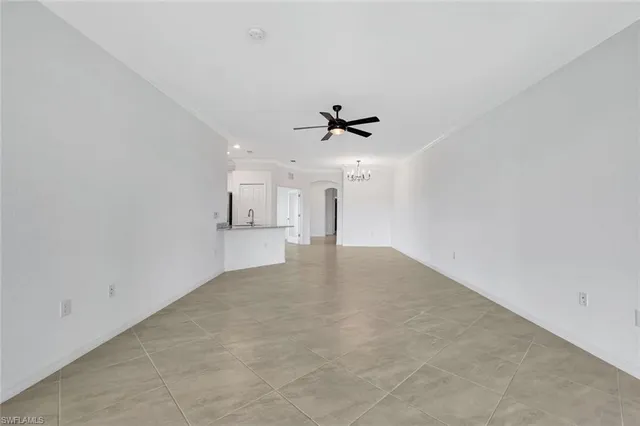 a view of a kitchen with a sink and a chandelier fan
