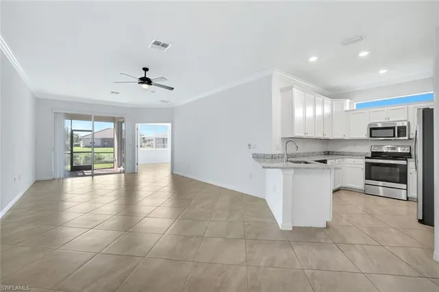 a view of kitchen with appliances and cabinets