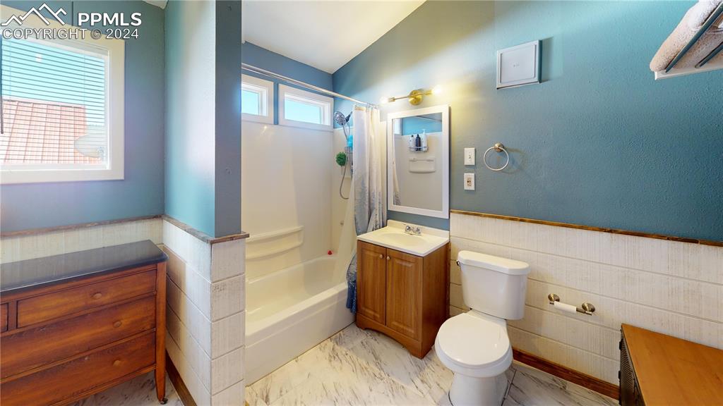 315 5th Street Victor, CO 80860 - Photo 24 of 39 a bathroom with a granite countertop toilet sink and mirror