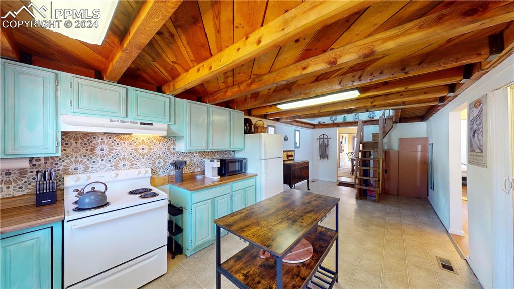 315 5th Street Victor, CO 80860 - Photo 9 of 39 a view of a kitchen with fridge and workspace