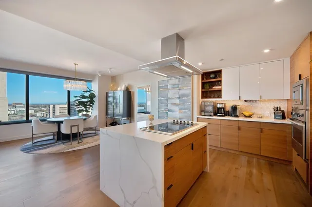 a kitchen with refrigerator cabinets and wooden floor
