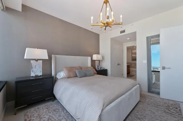 a bathroom with a double vanity sink mirror and bathtub