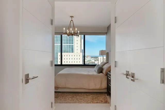 a bedroom with a large bed and a large window