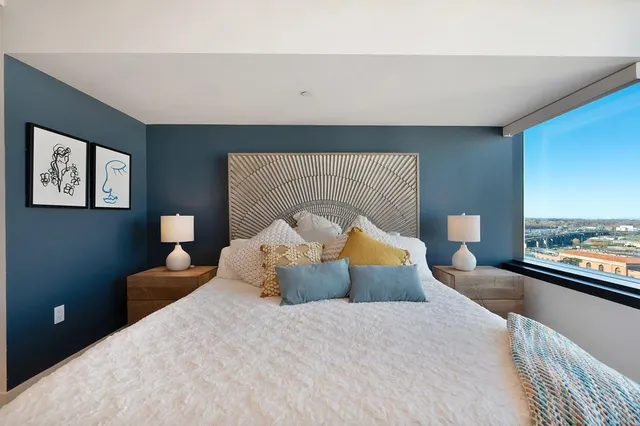 a bedroom with a large bed and a tv