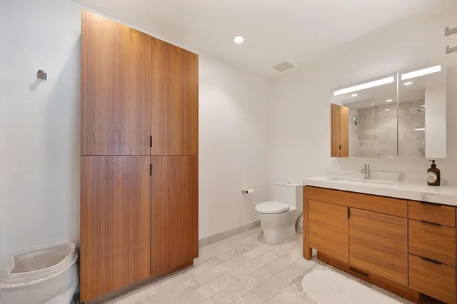 a spacious bathroom with a double vanity sink and a mirror