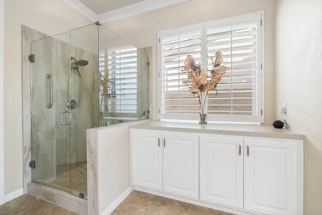 a bathroom with a shower and a window