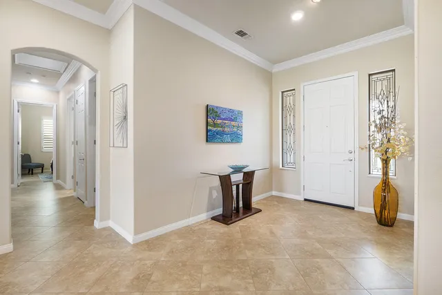 a view of a livingroom with furniture and a hallway