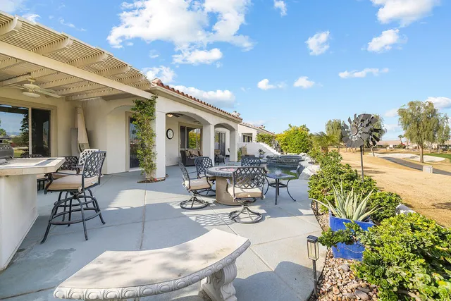 a view of a patio with table and chairs and potted plants