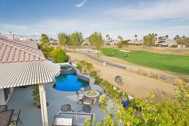 a view of a swimming pool with an outdoor seating
