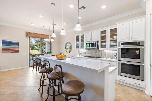 a kitchen with a table chairs stove and microwave