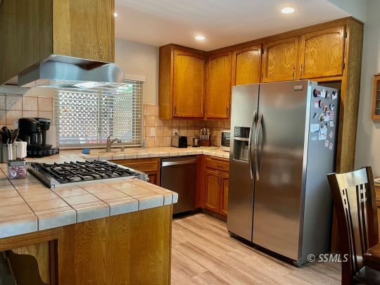 205 Chambers Street Ridgecrest, CA 93555 - Photo 6 of 32 a kitchen with a sink a counter top space and stainless steel appliances