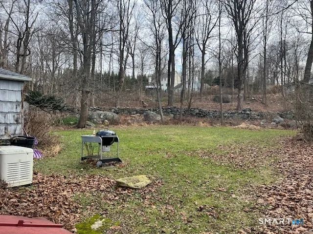 a view of a backyard with table and chairs