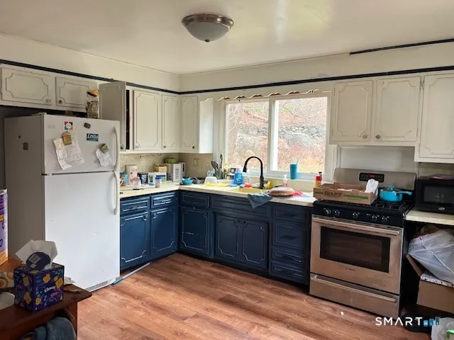 a kitchen with a refrigerator stove and sink