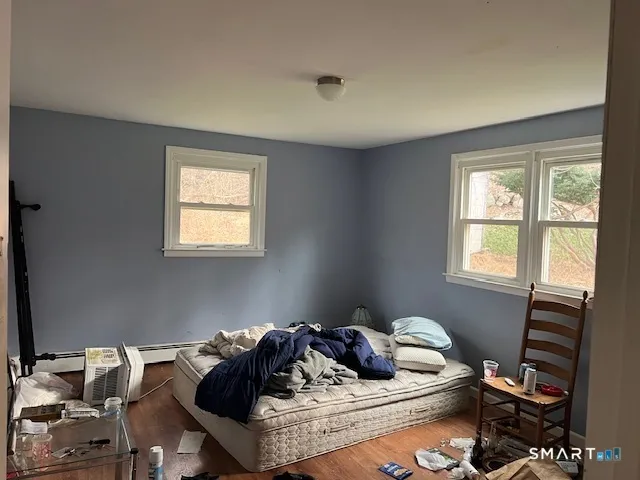 a bed sitting in a bedroom next to a window