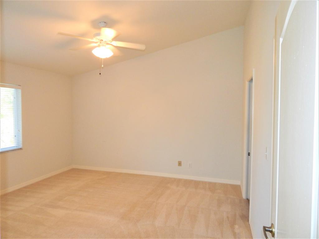 8065 Tiger Cove, Unit 1610 Naples, FL 34113 - Photo 7 of 11 an empty room with a window