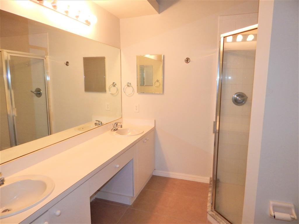 8065 Tiger Cove, Unit 1610 Naples, FL 34113 - Photo 8 of 11 a bathroom with a tub sink and mirror
