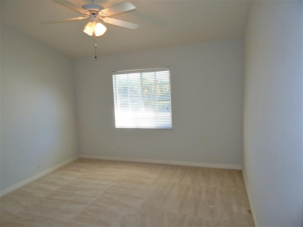 8065 Tiger Cove, Unit 1610 Naples, FL 34113 - Photo 9 of 11 an empty room with a window