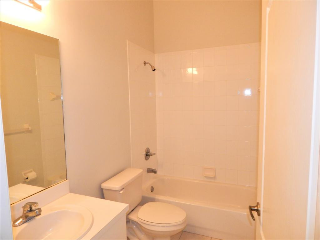 8065 Tiger Cove, Unit 1610 Naples, FL 34113 - Photo 10 of 11 a bathroom with a toilet a sink and bathtub