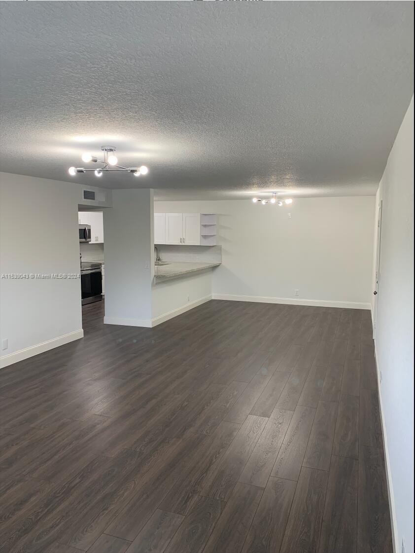 22735 Southwest 66th Avenue, Unit 101 Boca Raton, FL 33428 - Photo 8 of 27 a view of empty room with wooden floor