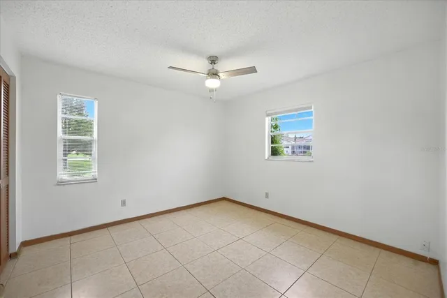 a bathroom with a granite countertop toilet a sink and a mirror