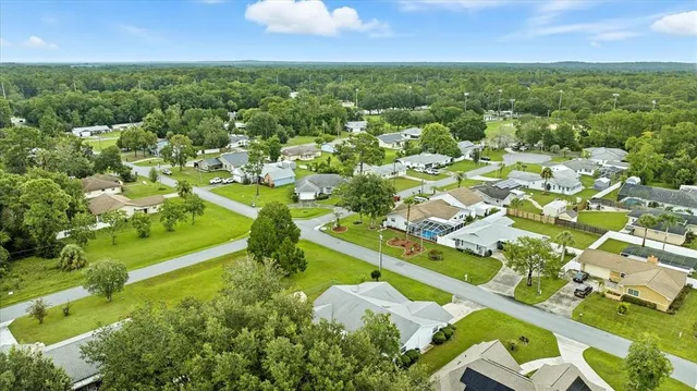 swimming pool view with a garden