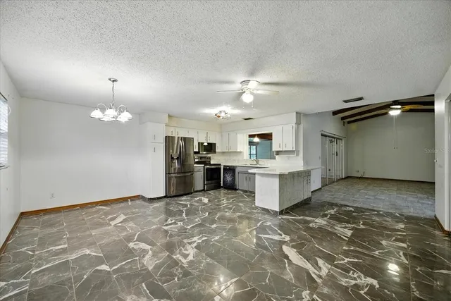 a view of a kitchen with a sink and cabinets