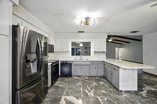 a kitchen with a sink stove and refrigerator
