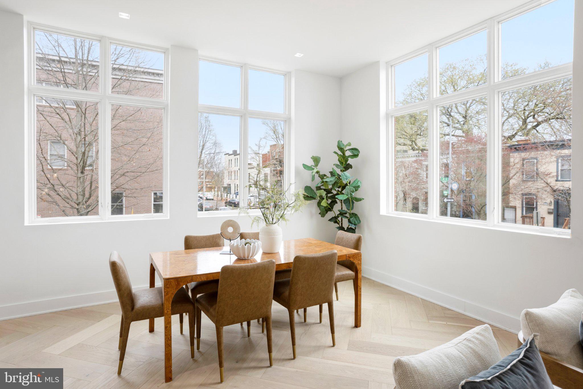 1212 4th Street Northwest, Unit 9 Washington, DC 20001 - Photo 12 of 42 a dining room with furniture potted plants and wooden floor