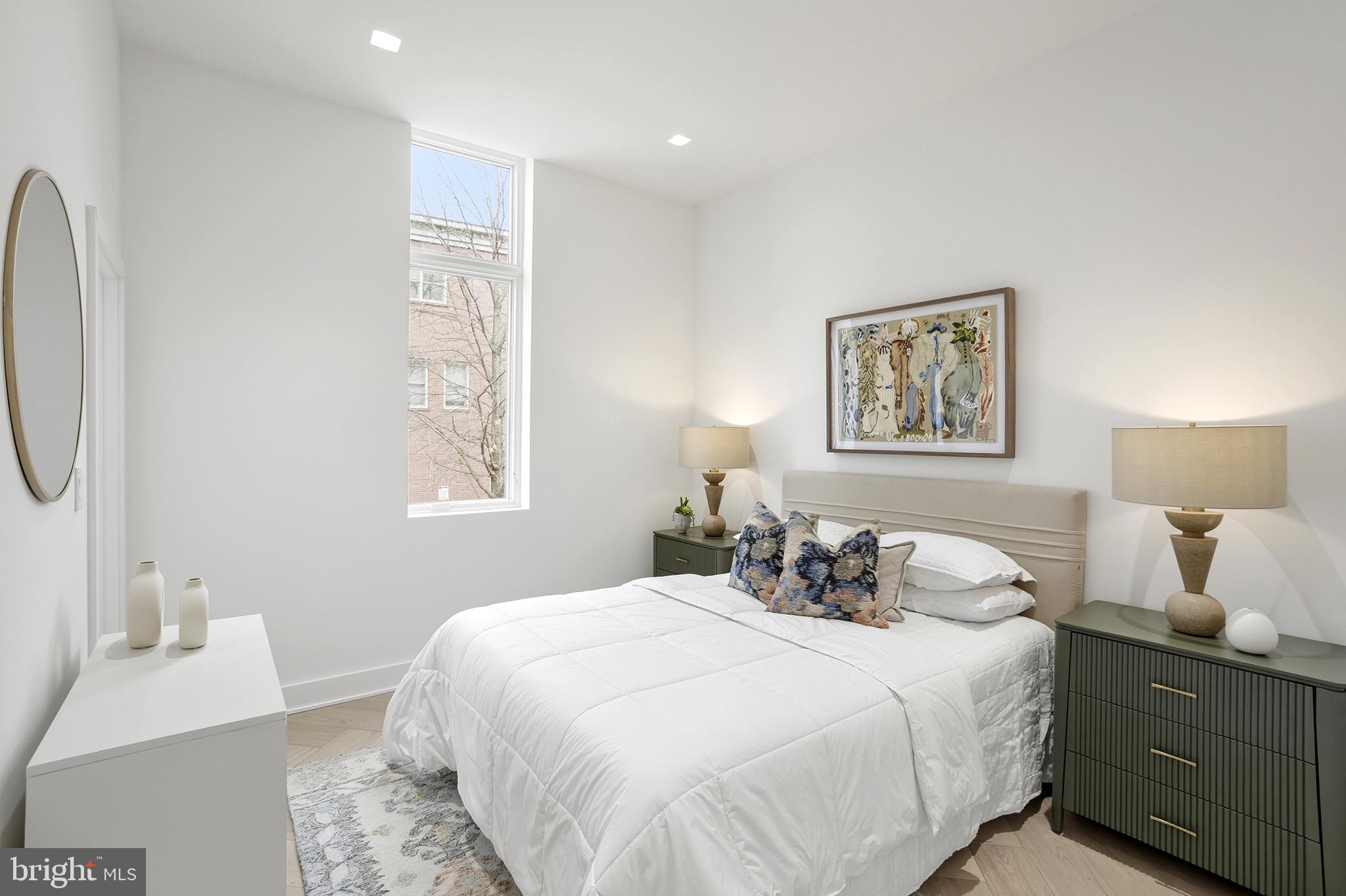 1212 4th Street Northwest, Unit 9 Washington, DC 20001 - Photo 19 of 42 a bedroom with a bed and a night stand