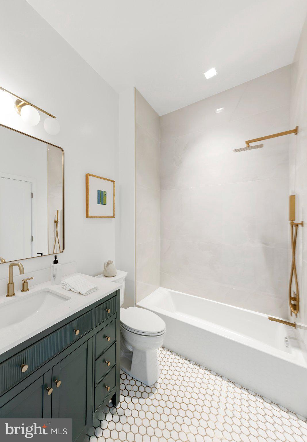 1212 4th Street Northwest, Unit 9 Washington, DC 20001 - Photo 21 of 42 a bathroom with a sink a toilet and a bathtub