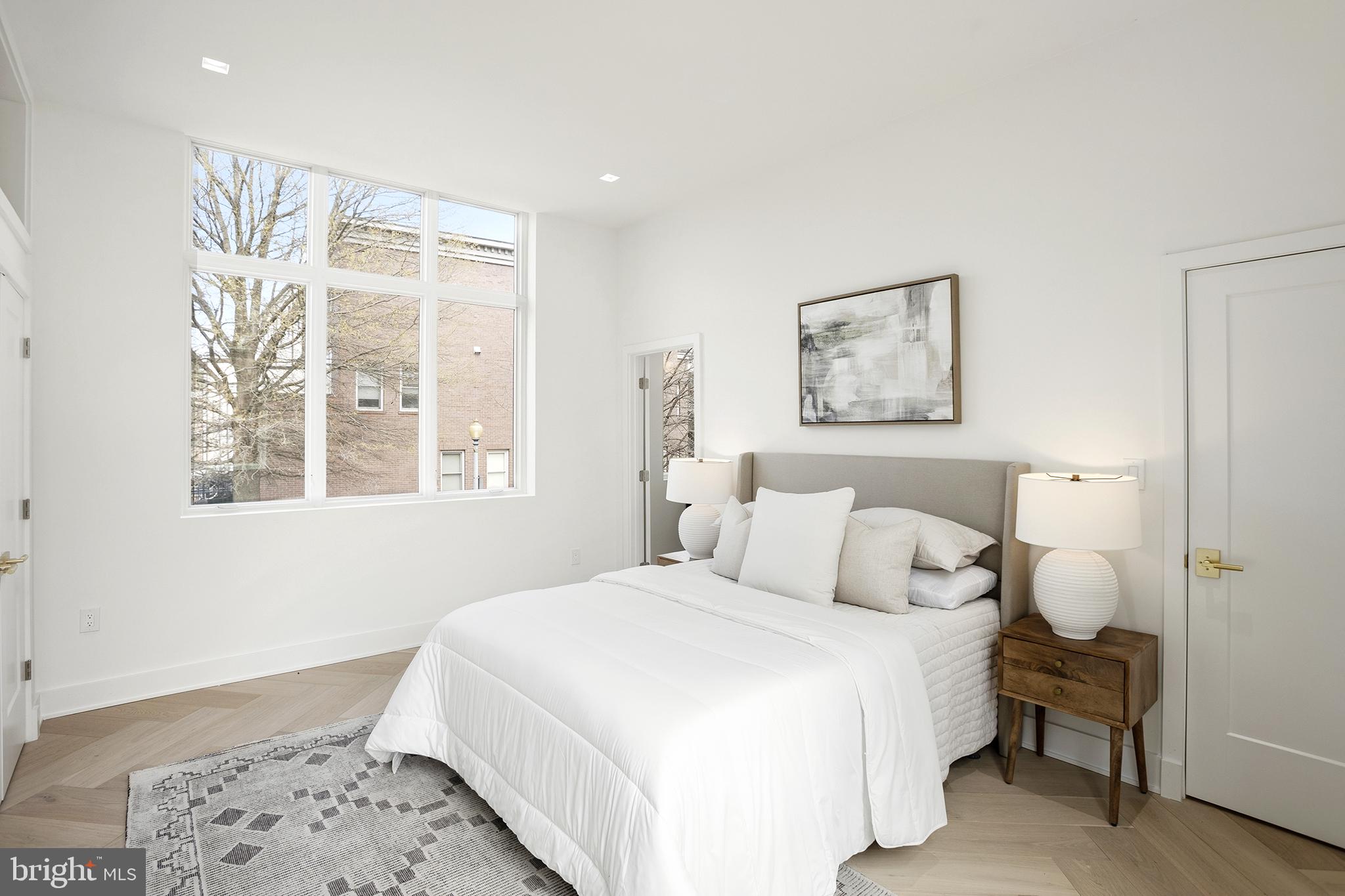 1212 4th Street Northwest, Unit 9 Washington, DC 20001 - Photo 24 of 42 a bedroom with a large bed and a window