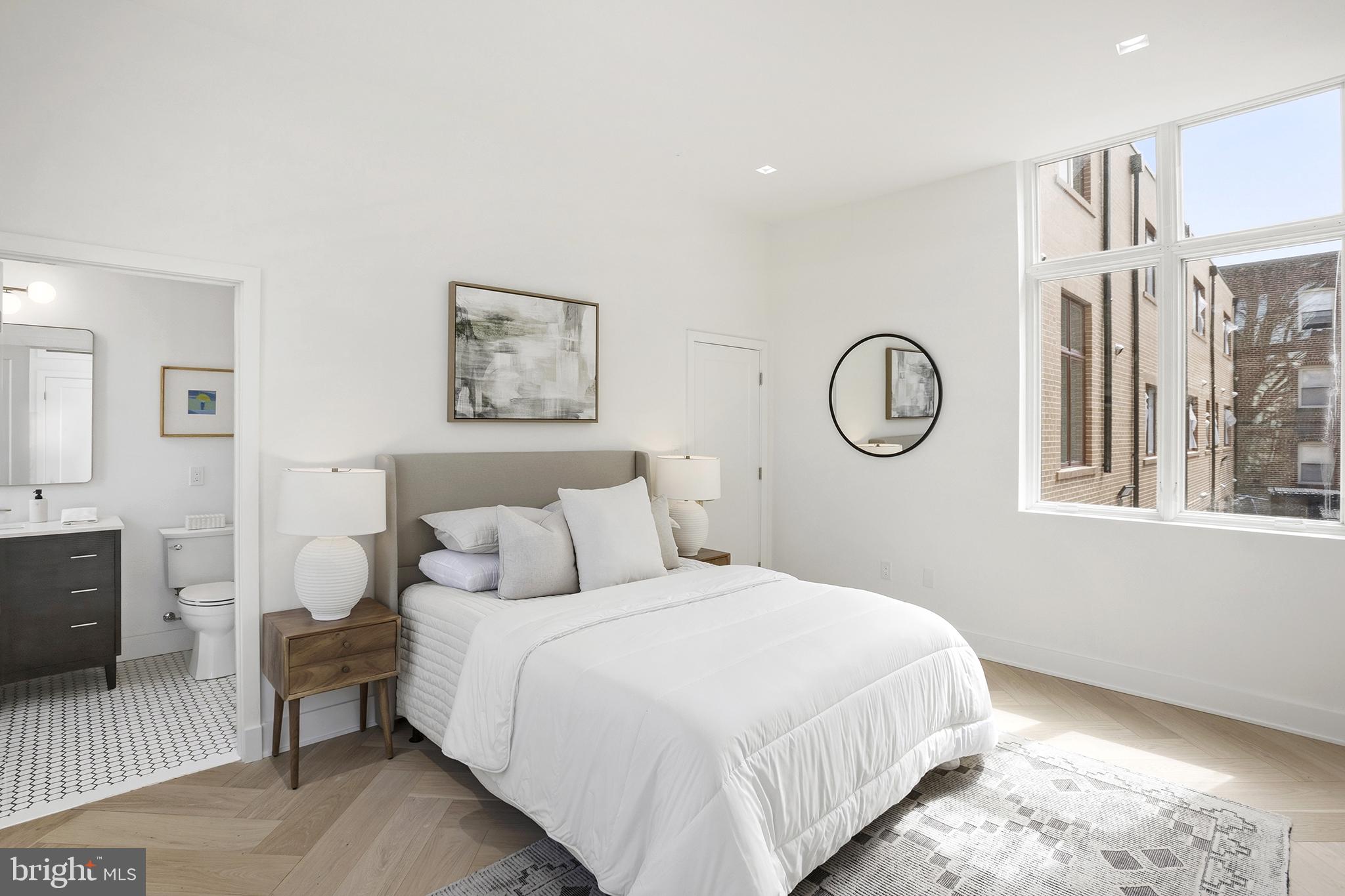 1212 4th Street Northwest, Unit 9 Washington, DC 20001 - Photo 25 of 42 a bedroom with a large bed and a chandelier