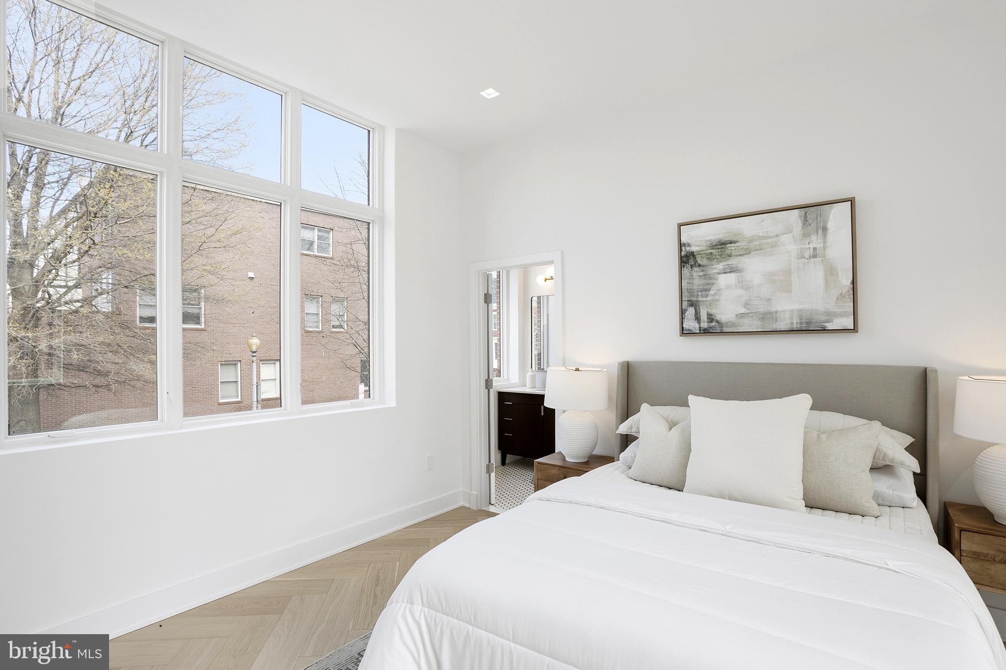 1212 4th Street Northwest, Unit 9 Washington, DC 20001 - Photo 28 of 42 a bedroom with a large bed and a large window
