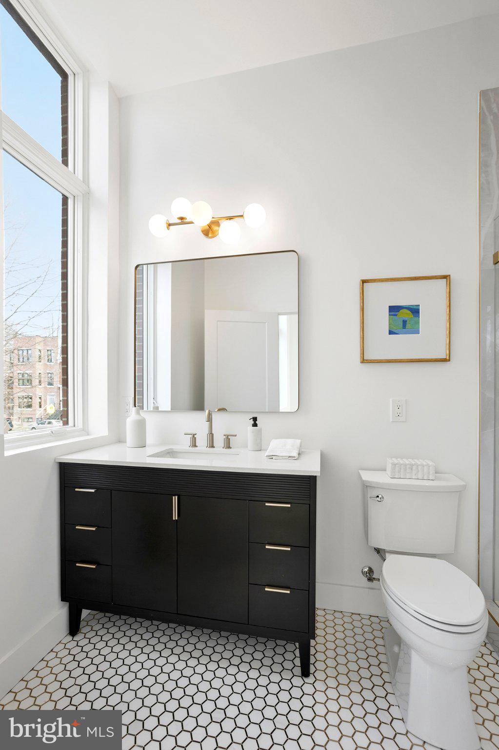 1212 4th Street Northwest, Unit 9 Washington, DC 20001 - Photo 30 of 42 a bathroom with a sink vanity mirror and toilet