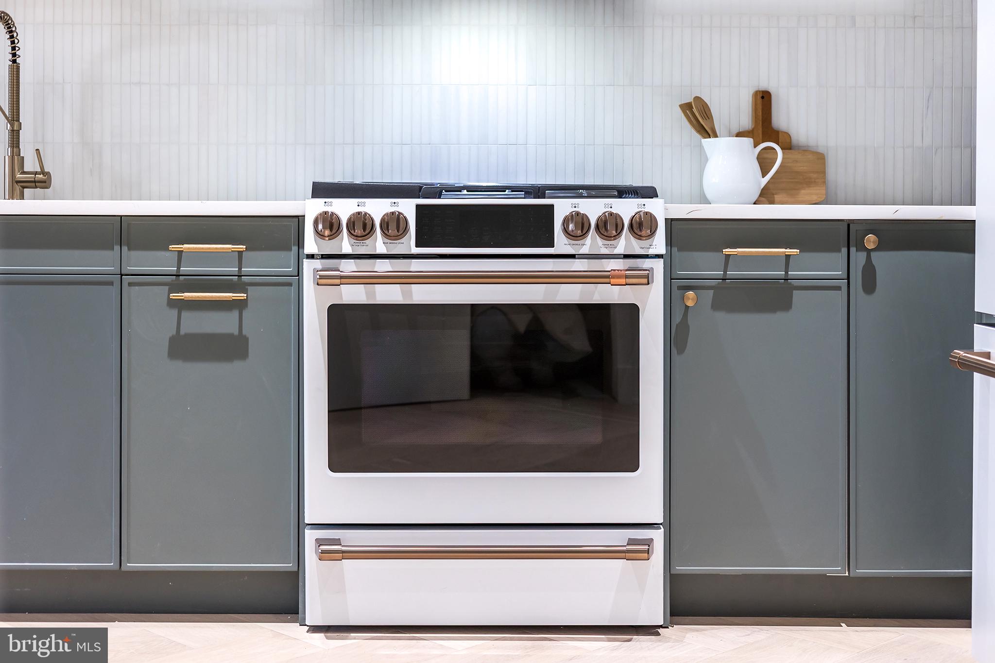 1212 4th Street Northwest, Unit 9 Washington, DC 20001 - Photo 33 of 42 a stove top oven sitting inside of a kitchen