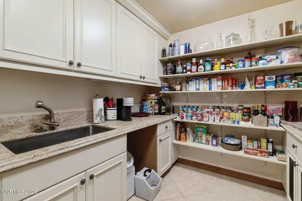 a living room with furniture a clock and a large window