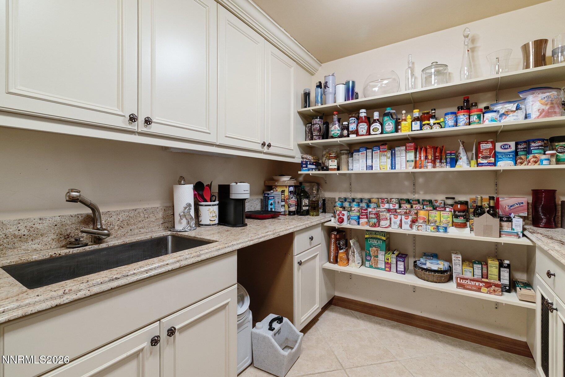 360 Sylvan Court Verdi, NV 89439 - Photo 13 of 76 a kitchen with a lot of white cabinets and a wooden floor