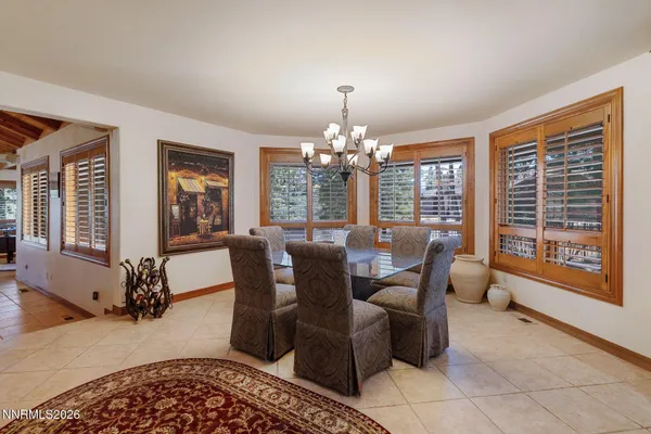 a living room with furniture a chandelier and a large window