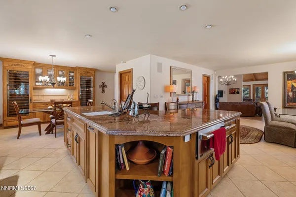 a spacious bedroom with a bed and a dresser