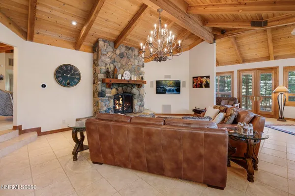 a en suite bathroom with a granite countertop sink and a large mirror