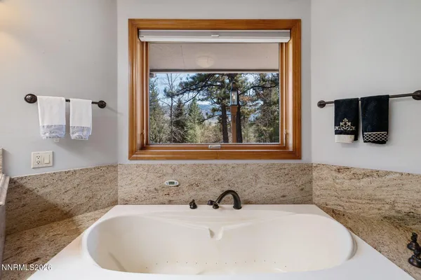 a view of a patio with table and chairs and wooden floor