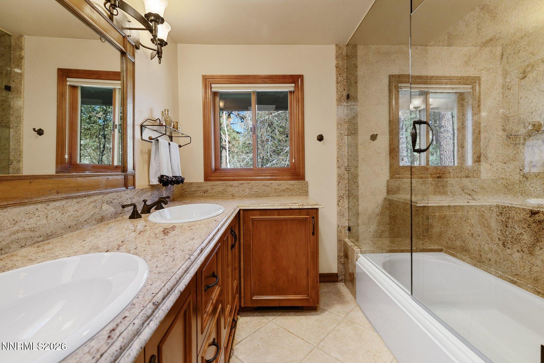 360 Sylvan Court Verdi, NV 89439 - Photo 32 of 76 a bathroom with a granite countertop tub sink and mirror