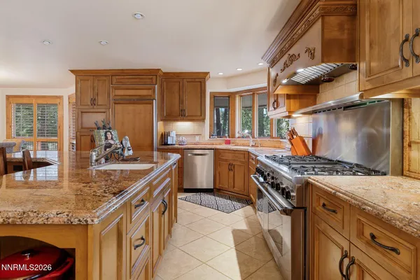 a kitchen with a lot of white cabinets and a wooden floor