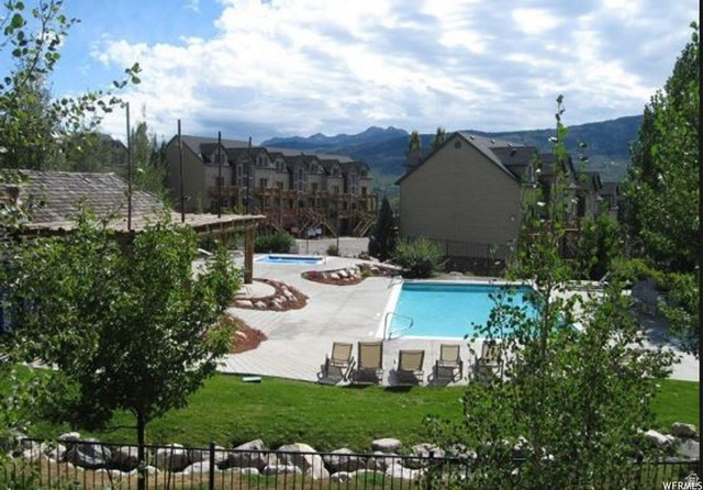 5168 Fairview Loop, Unit C604 Eden, UT 84310 - Photo 44 of 53 Community pool featuring a patio area and a mountain view