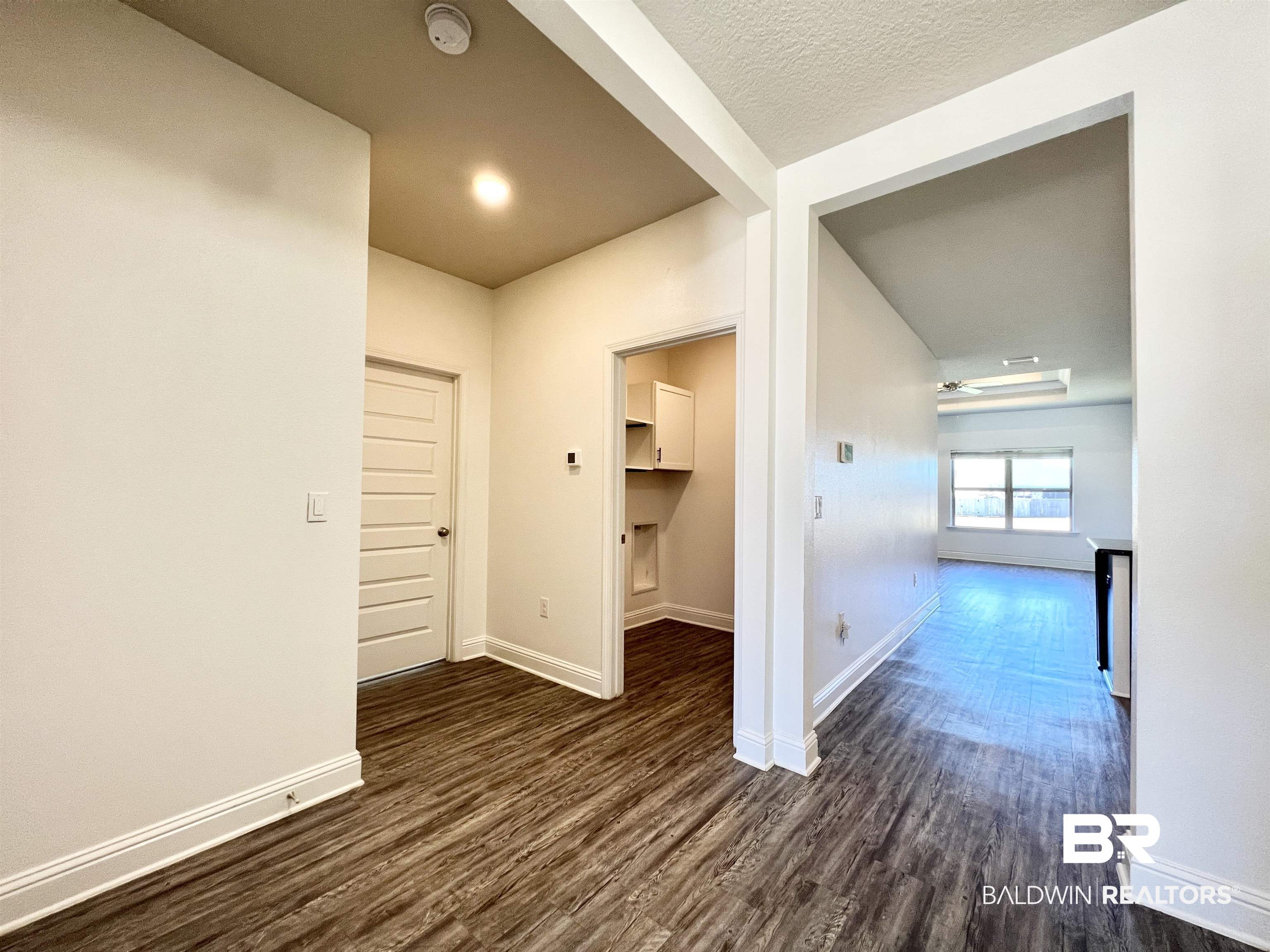 24785 Slater Mill Road Daphne, AL 36526 - Photo 20 of 46 Corridor featuring a textured ceiling and dark hardwood / wood-style floors