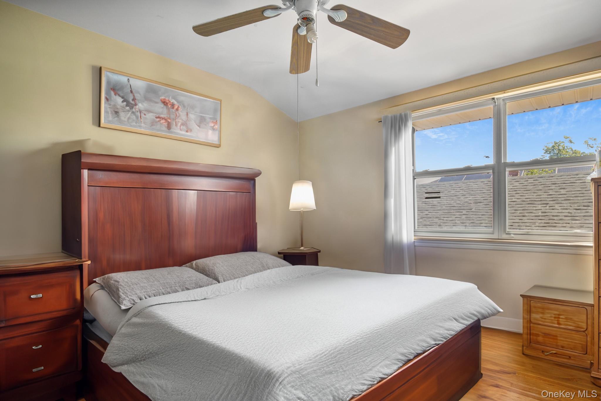 135-06 62nd Road Queens, NY 11367 - Photo 12 of 20 a bedroom with a large bed and a window